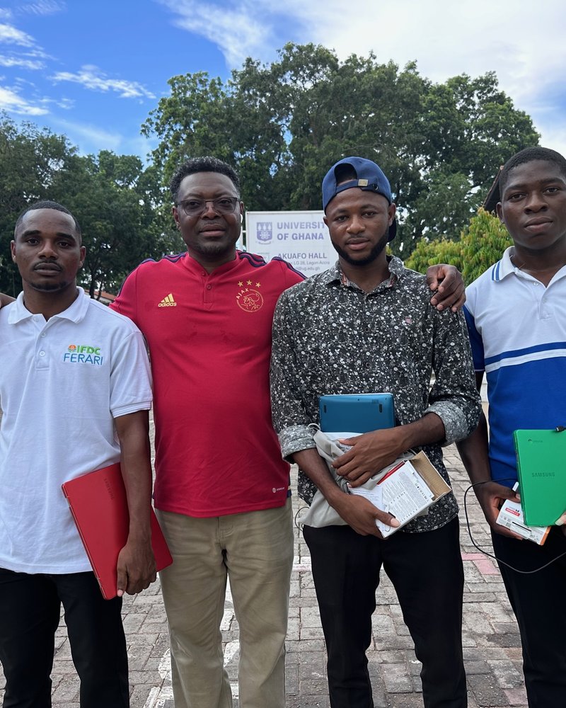Fr-Dominic-presenting-a-Chromebooks-to-Mr.-Isaac-L-of-the-University-of-Ghana-UG-Legon_-Mr.-Amidu-UPSA-and-Mr.-Daniel-of-UG-Legon-during-his-summer-2023-visit-to-Ghana