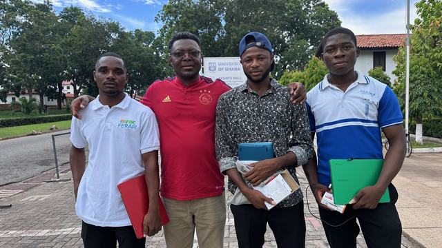Fr-Dominic-presenting-a-Chromebooks-to-Mr.-Isaac-L-of-the-University-of-Ghana-UG-Legon_-Mr.-Amidu-UPSA-and-Mr.-Daniel-of-UG-Legon-during-his-summer-2023-visit-to-Ghana