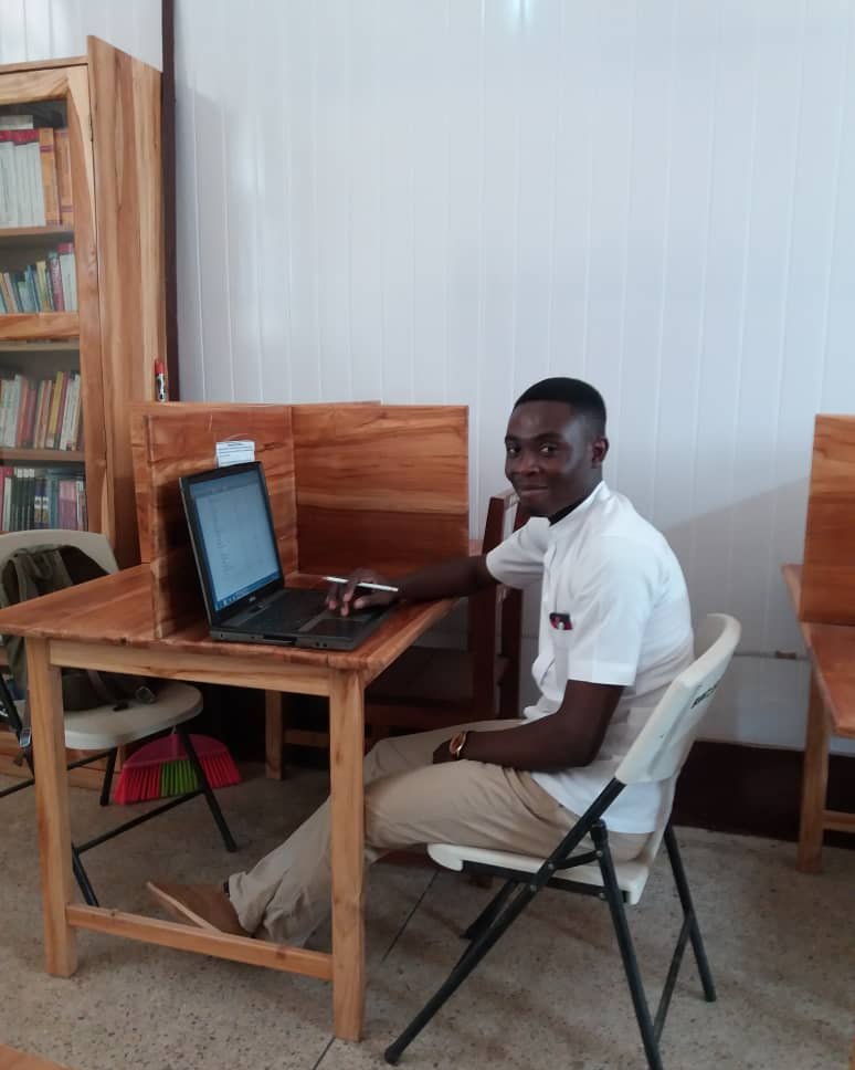 Wilfred-one-of-our-nursing-school-graduates-using-a-laptop-we-presented-to-him-in-2016
